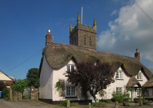 Sheepwash Church, Devon with thatched cottage.