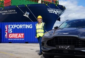 Liz Truss in front of big export poster