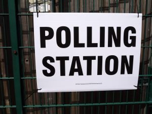 Polling station sign fixed to mesh fence