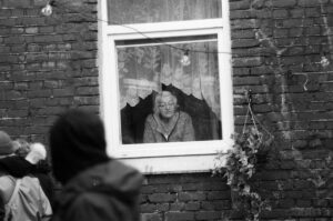 elderly woman in window looking out