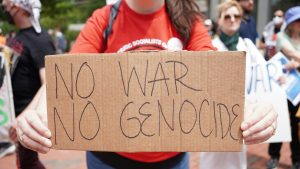 woman holding anti genocide sign